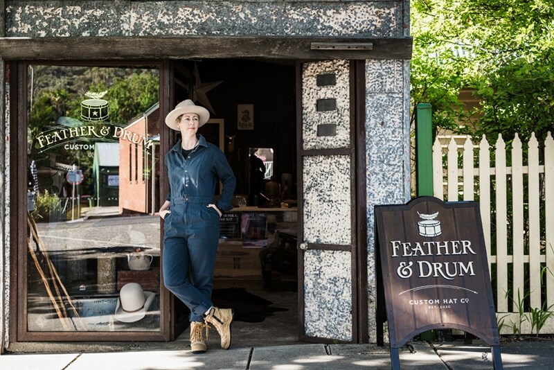 Entrance of Feather and Drum store open door, and sign reading 'Feather & Drum'.