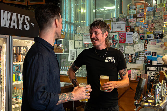 Ross Tipper shares a beer with OneMusic's Jeremy Davidson at their brewery bar in Newtown, NSW.