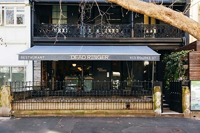 Front of Dead Ringer restaurant with black exterior, white signage, and a fenced patio at 413 Bourke Street.