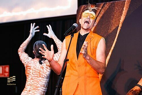 Mitch Tambo performing live with a dancer in the background