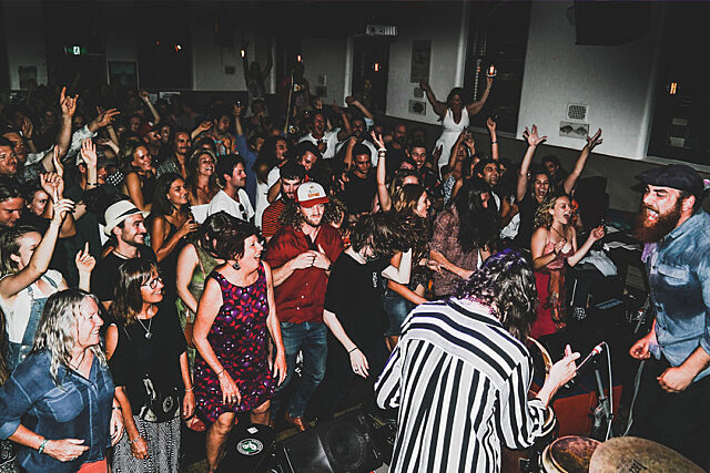 Crowd dancing and enjoying themselves at Clancy's venue.
