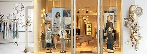 Entrance of Mega Park Fitzroy store with mannequins, clothing racks, and decorative wall art.
