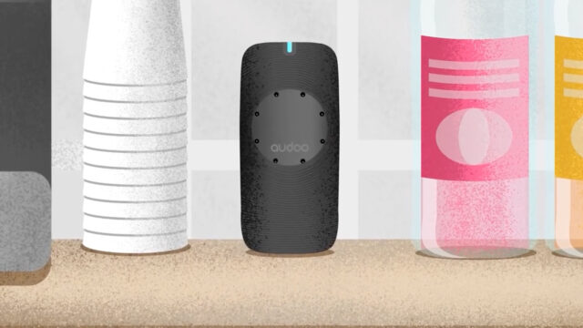 Black cylindrical device labeled 'audoo' on a countertop between white cups and bottles.